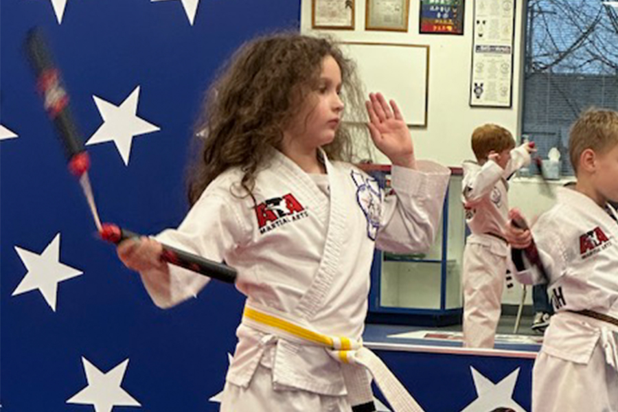 Tiny Tigers student practicing with a training weapon at North Canton ATA